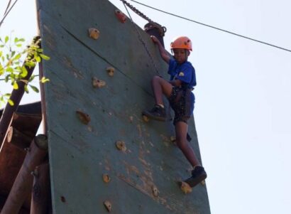 A climbing wall provides a common objective for the team to rally around